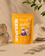 Kelpie Balance chews pouch on a studio plinth with stones, 30 chews, 90 g